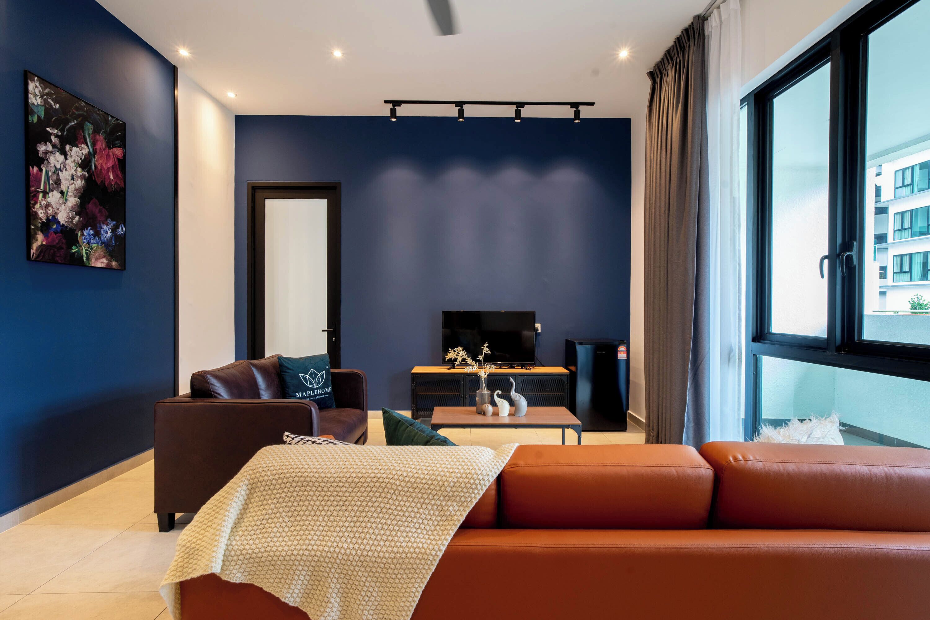 A modern living room with a sofa, a coffee table, and a television.