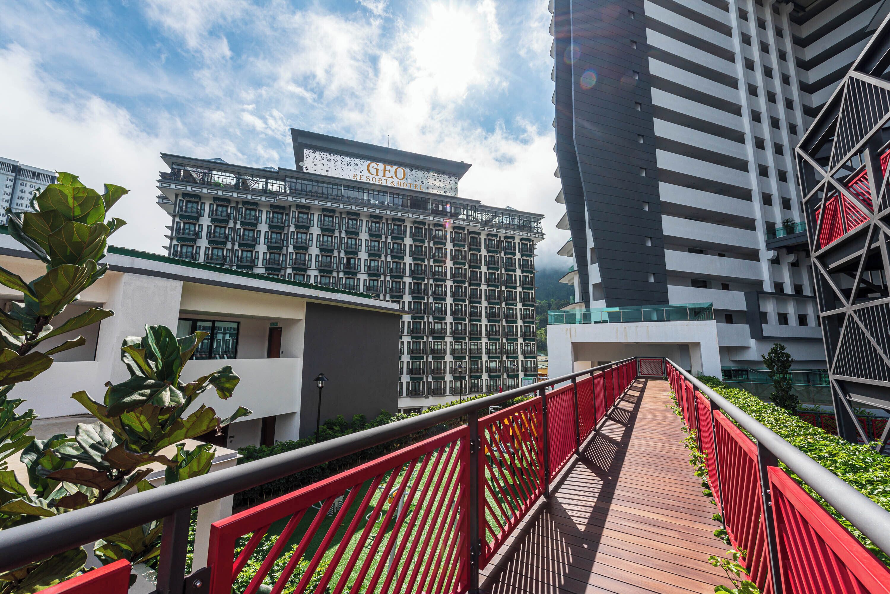 A modern building with a sign reading 'GEO RESORT & HOTEL'.
