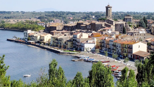 A coastal town with historic buildings, a prominent tower, and a marina with boats. - Lovely apartment in villa for 5 people with WIFI, pool and patio (Vaiano)