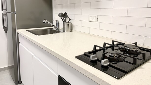 A kitchen with a stainless steel refrigerator, a double sink, and a gas stove. - next to Soroka and BGU (Beer sheva)