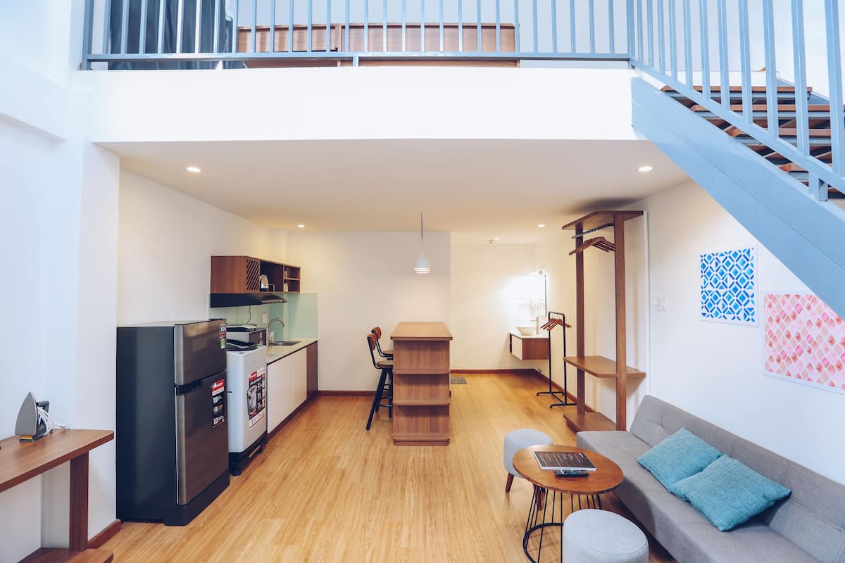 A modern apartment with a kitchen, dining area, and living room.
