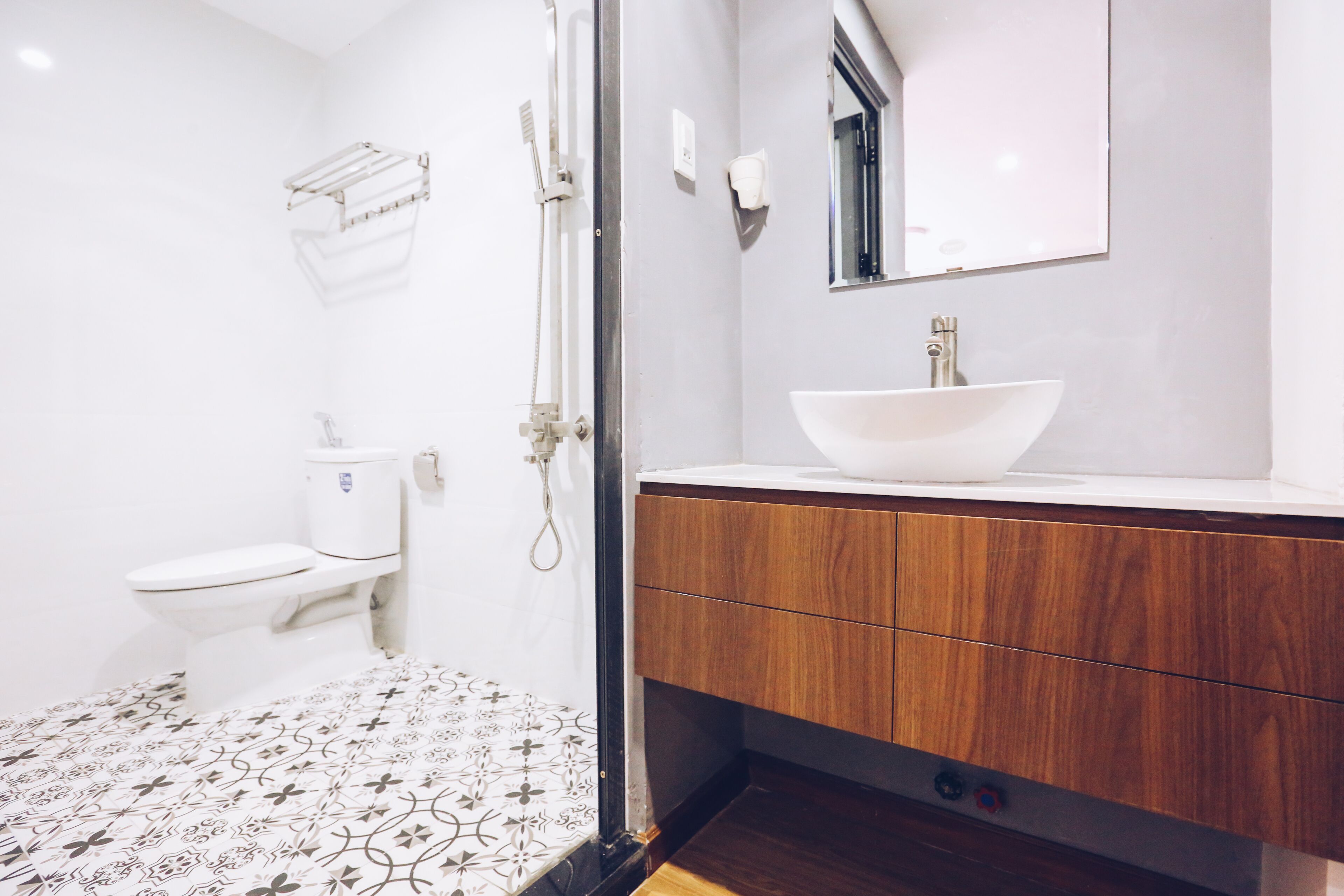 A bathroom with a toilet, a sink, and a shower.