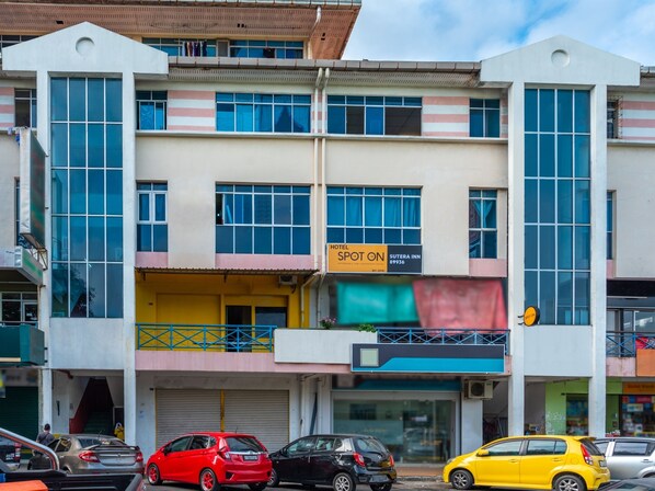 A multi-story building with a hotel named "Sutera Inn" on the ground floor. - SPOT ON 89936 Sutera Inn (Kota Kinabalu)