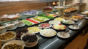 A buffet with various food items including salads, meats, cheeses, and olives. - Samsun Airport Resort Hotel (Tekkekoy)