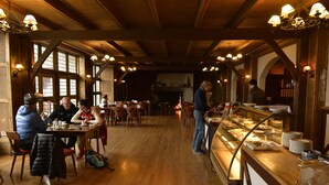 A restaurant with wooden beams, tables, and a buffet area. - Fossli Hotel (Eidfjord)