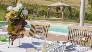 A table set for dining with a pool and gazebo in the background. - Villa Gemma, revalue wonder of nature near Lake Bolsena (Narni)