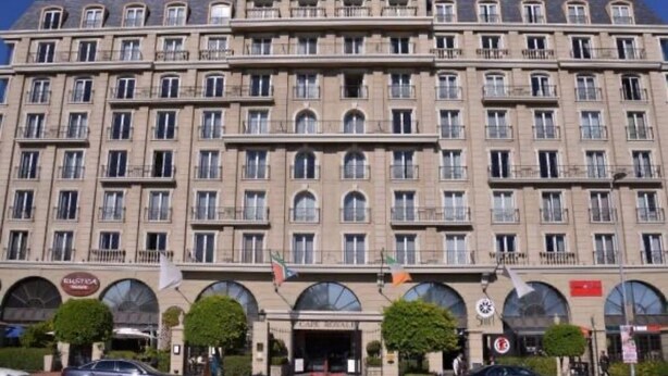 A large, multi-story hotel with a symmetrical facade, numerous windows, and a central entrance.