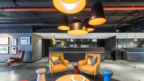 A modern office space with a reception area, seating arrangements, and artwork on the walls. - Opus tower (Southbank)