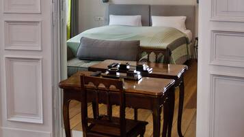 A bedroom with a bed, bedside table, and a chair.