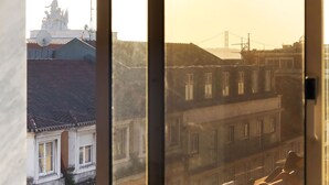A view through a window of a building with multiple floors, featuring a mix of architectural styles. - Downtown Experience By Homing (Lisbon)