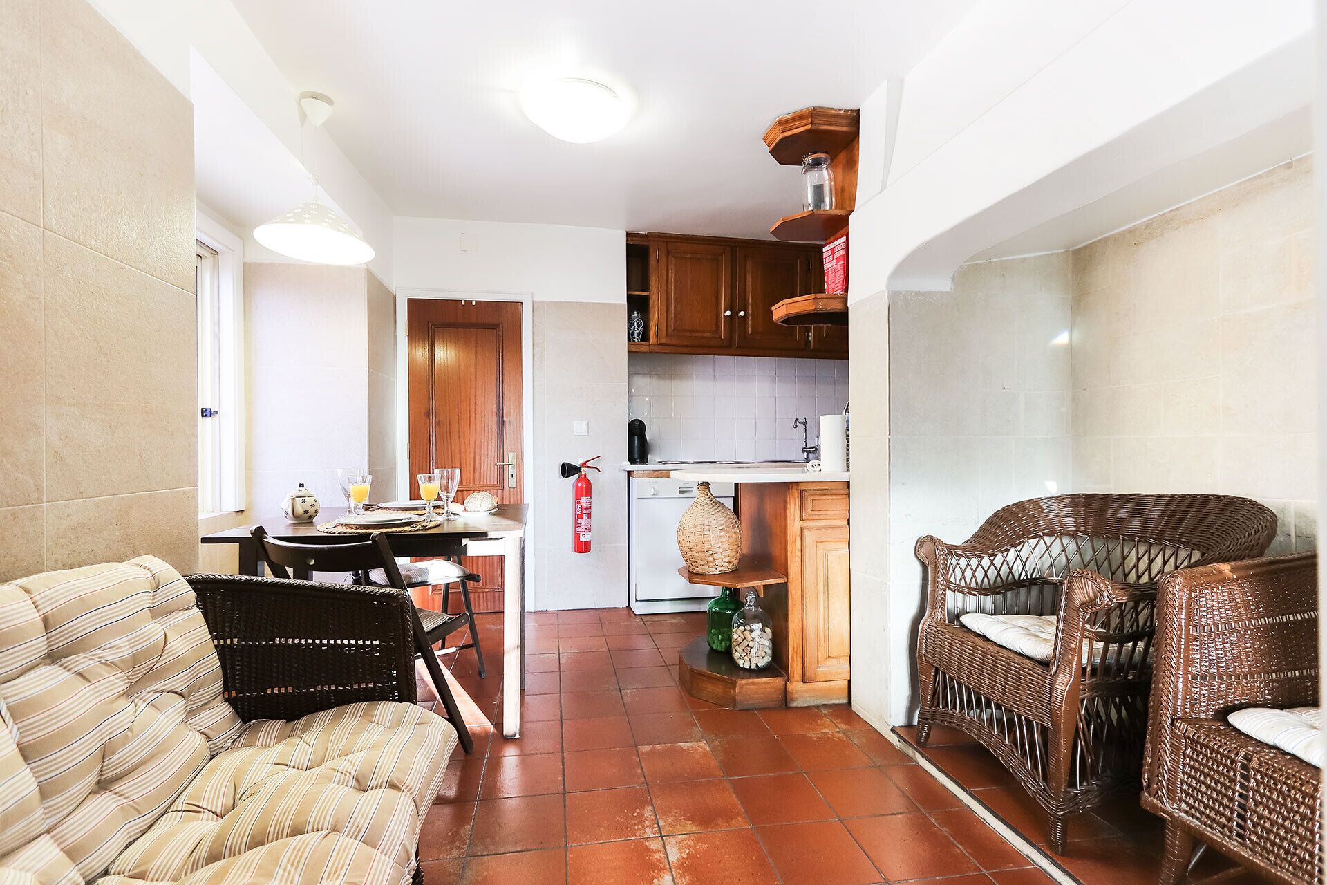 A compact living space with a dining area, kitchen, and seating area.
