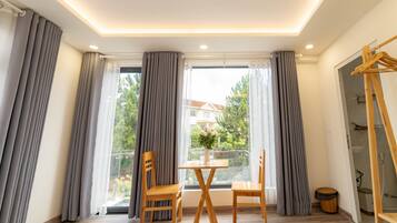 Deluxe Room | Desk, laptop workspace, blackout drapes, iron/ironing board