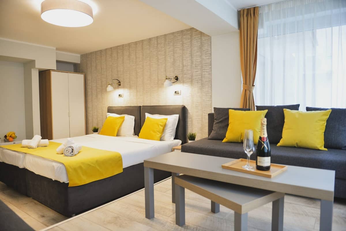 Deluxe Quadruple Room | Minibar, in-room safe, desk, laptop workspace