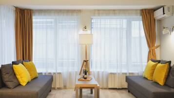 Deluxe Quadruple Room | Minibar, in-room safe, desk, laptop workspace