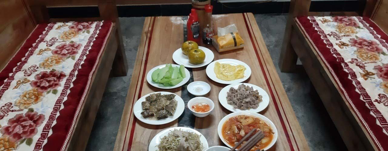 A dining table with various dishes and condiments.