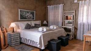 A neatly arranged bedroom with a bed, bedside tables, a mirror, and a small desk. - Bastille de Blignaut B&B (Edenvale)