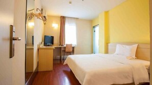 A hotel room with a bed, desk, chair, television, and a mirror. - 7Days Inn Chain Hotel (Shanghai Jiangning Road Subway Station Jade Buddha Temple) (Shanghai)