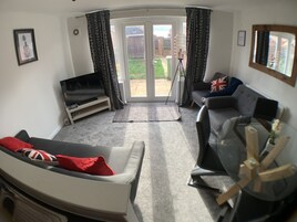 Business Townhome | Living area | Flat-screen TV