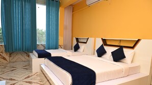 A hotel room with two beds, a large window with curtains, and a marble-patterned floor.