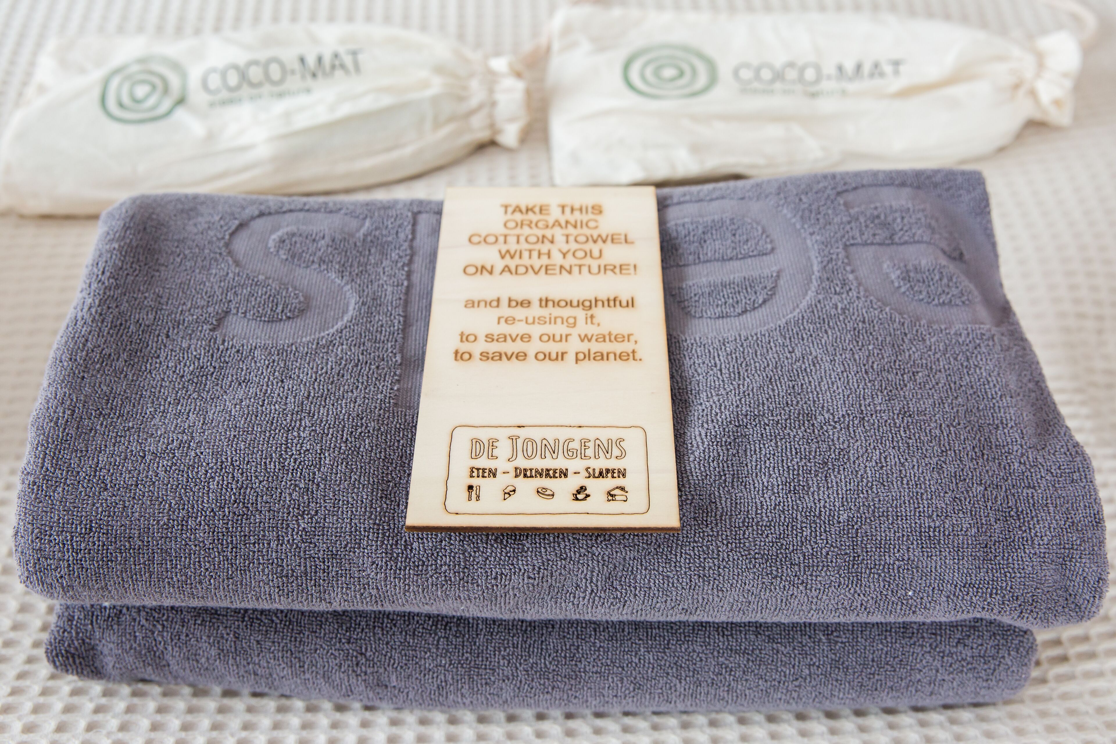 A folded organic cotton towel with a tag.