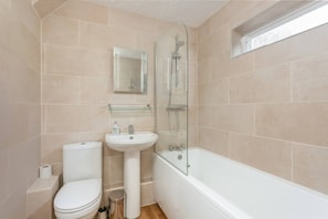 A bathroom with a toilet, sink, and bathtub.