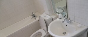 A bathroom with a toilet, bidet, and sink. - Maxoil Hotel (Nanyuki)