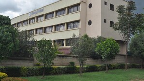 A building with a flat facade, multiple windows, and a sign that reads "Maxwell Hotel". - Maxoil Hotel (Nanyuki)