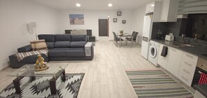 A modern apartment with a living area, dining space, and kitchen.