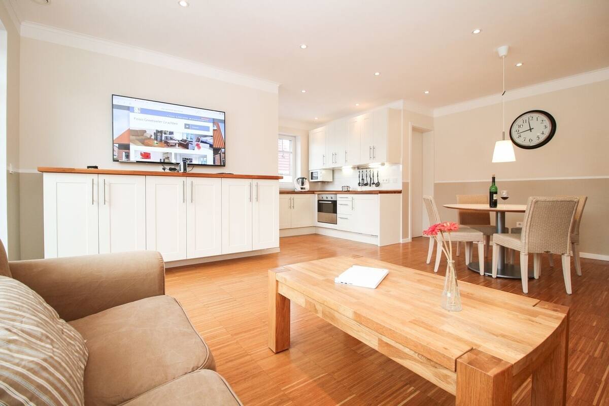 A modern apartment with a living room, kitchen, and dining area.