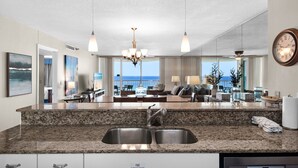 A modern kitchen with granite countertops, stainless steel sinks, and a built-in fire extinguisher. - Beach Front, Balcony, Free Beach Chair Service, Tennis Pros (Miramar Beach)