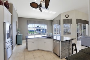 Enjoy cooking in this well-equipped kitchen with a large island, sink, and ample counter space.