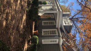 A two-story house with a front porch, a garage, and a driveway. - Exclusive Myers Park RNC Rental 4000 sq ft Home - RENOVATED 15 min. to downtown (Charlotte)
