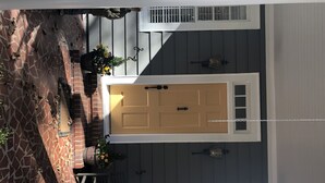 A house with a front door, a window, and a staircase. - Exclusive Myers Park RNC Rental 4000 sq ft Home - RENOVATED 15 min. to downtown (Charlotte)