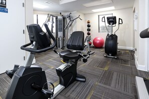 A gym with cardio equipment, weight machines, and exercise balls. - Surf Dweller 709 - Tidal Treasures (Fort Walton Beach)