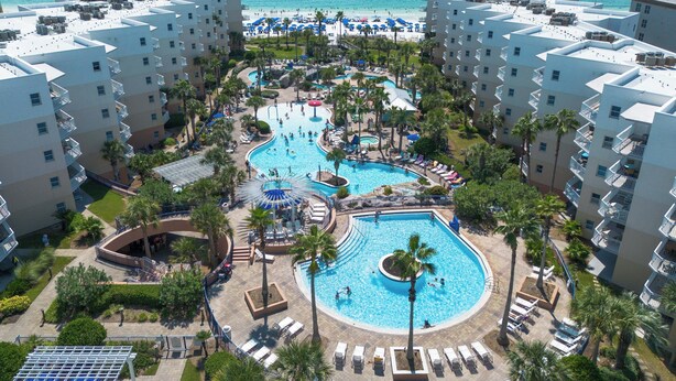 A resort with multiple swimming pools, a beach, and a view of the ocean. - Waterscape B310 - Resort Shores (Fort Walton Beach)