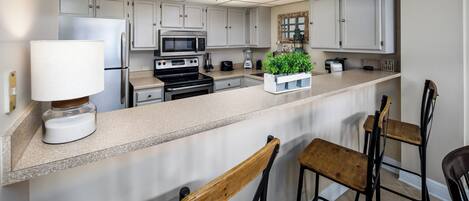 Condo | Private kitchen | Microwave, coffee/tea maker, cookware/dishes/utensils