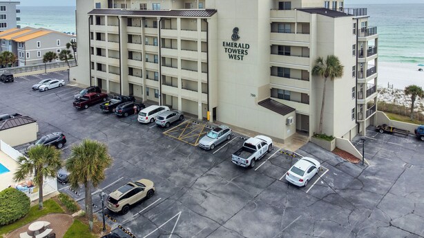 A multi-story parking garage with a view of the ocean. - Emerald Towers West 1003 - Sandy Toes (Fort Walton Beach)