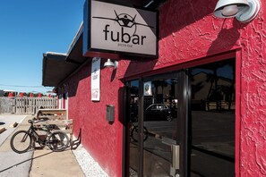A red building with a sign reading "fubar pizza bar". - Emerald Towers West 5004 - Beachside Memories (Fort Walton Beach)
