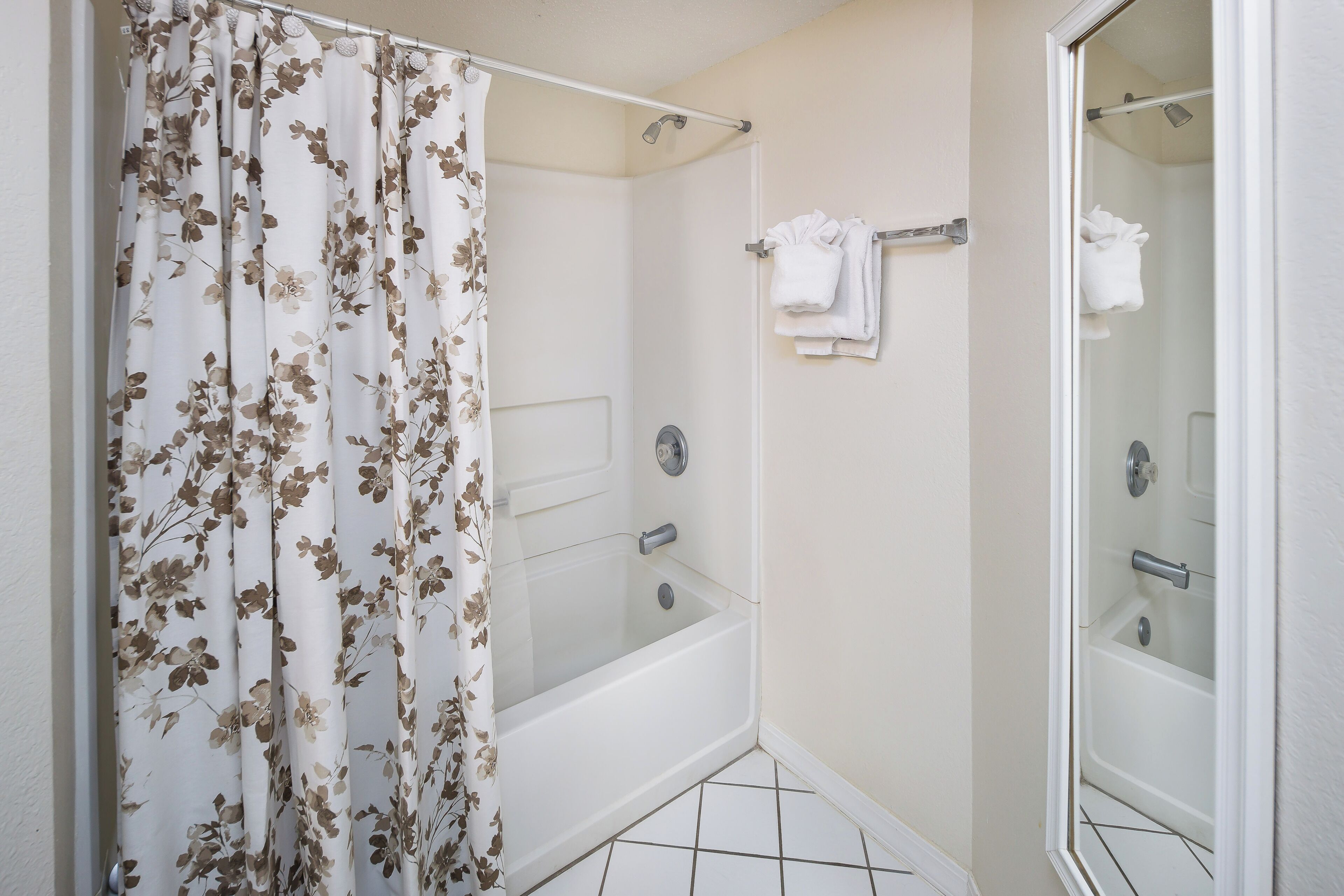 A bathroom with a shower, a bathtub, and a toilet.