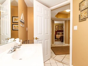 A bathroom with a large sink, a mirror, and a towel rack. - Islander 7008 - Memories by the Sea (Fort Walton Beach)