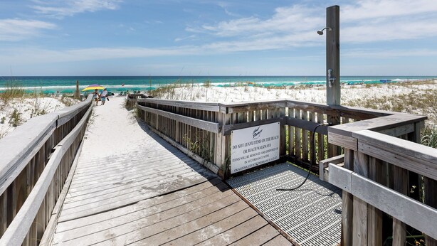 A wooden boardwalk leading to a beach with a sign warning against leaving items on the beach. - Gulf Dunes 617 - Sand Dollar Daze (Fort Walton Beach)