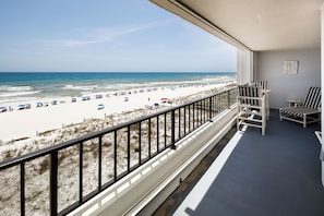 A balcony with a view of a beach, a railing, and a few chairs. - Surf Dweller 502 - The Dune Retreat (Fort Walton Beach)