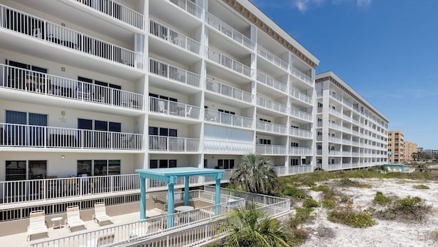 A multi-story hotel with balconies, outdoor seating, and a beach view. - Gulf Dunes 207 - Blue Skies & Beach Vibes (Fort Walton Beach)