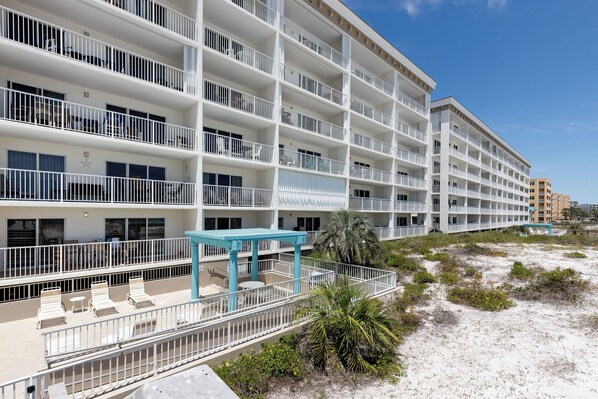 A multi-story hotel with balconies, outdoor seating, and a beach view. - Gulf Dunes 207 - Blue Skies & Beach Vibes (Fort Walton Beach)