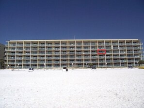 A multi-story hotel with balconies, located near a beach. - Pelican Isle 406 - Sunset Shores (Fort Walton Beach)