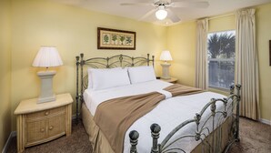 A bedroom with a bed, two bedside tables, a ceiling fan, a window with curtains, and a wall-mounted picture. - Islander 3004 - Coral Dreams (Fort Walton Beach)