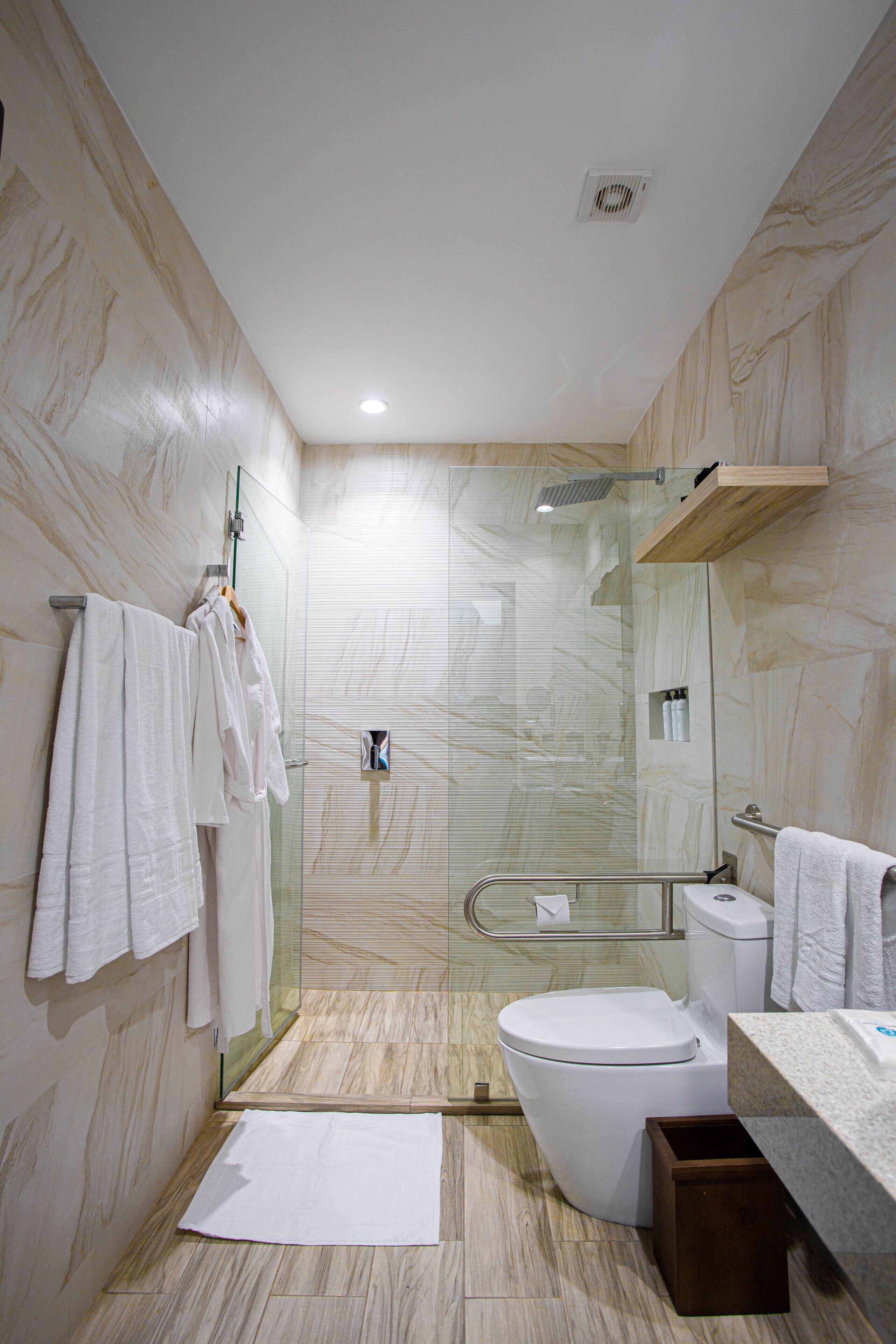 premium studio suite | bathroom | shower, rainfall showerhead, hair dryer, towels