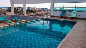 Relax by the pool surrounded by a city view.
