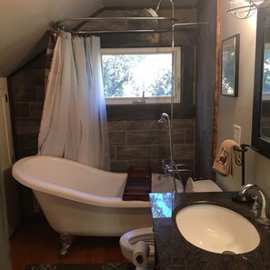 Combined shower/bathtub, towels, toilet paper