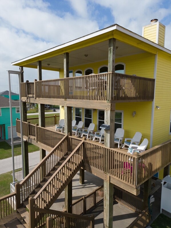 A two-story wooden building with a balcony and outdoor seating area.